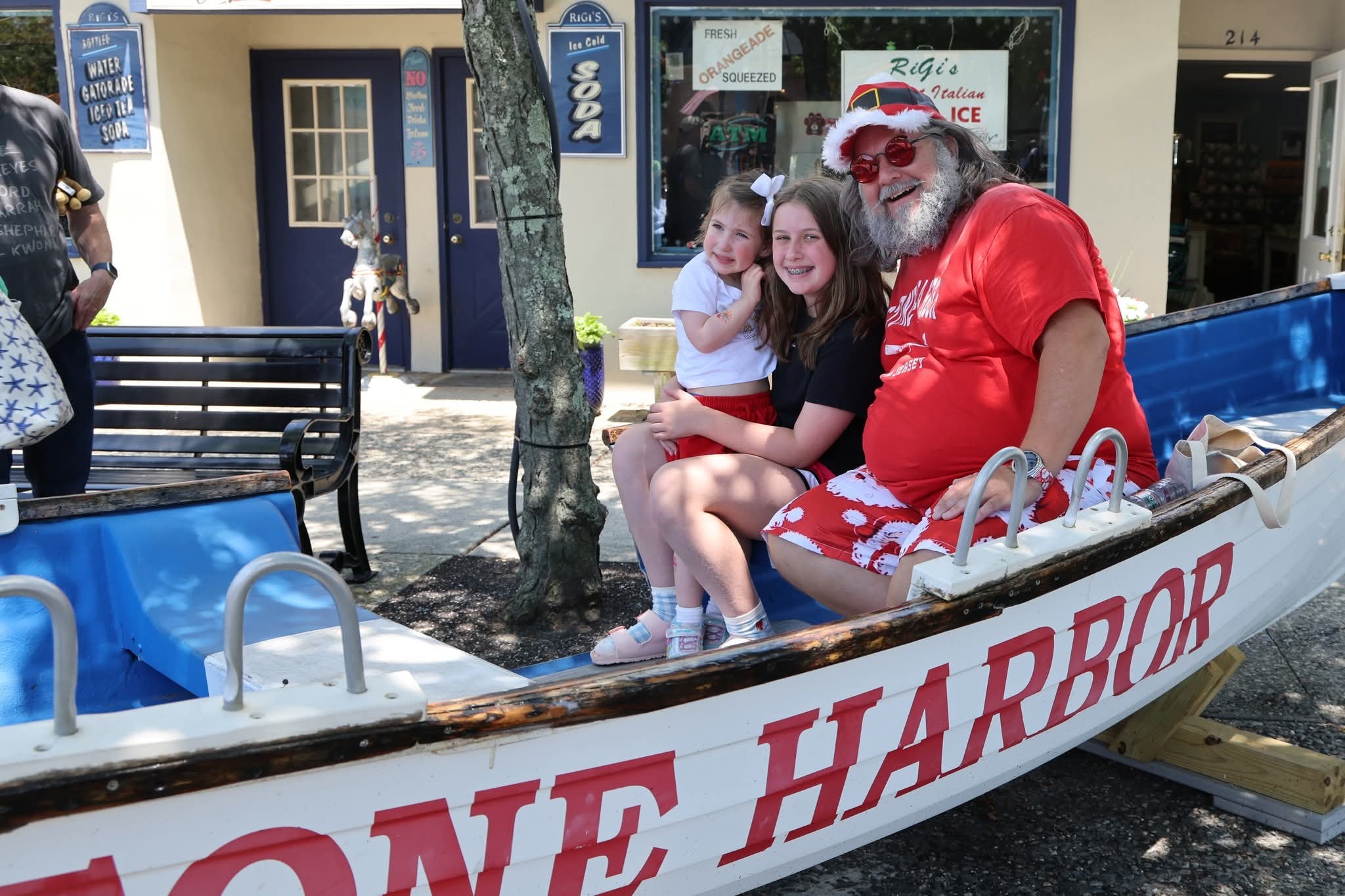 Cape May County Santa with two girls in the Stone Harbor boat, RiGi's Water Ice in the background