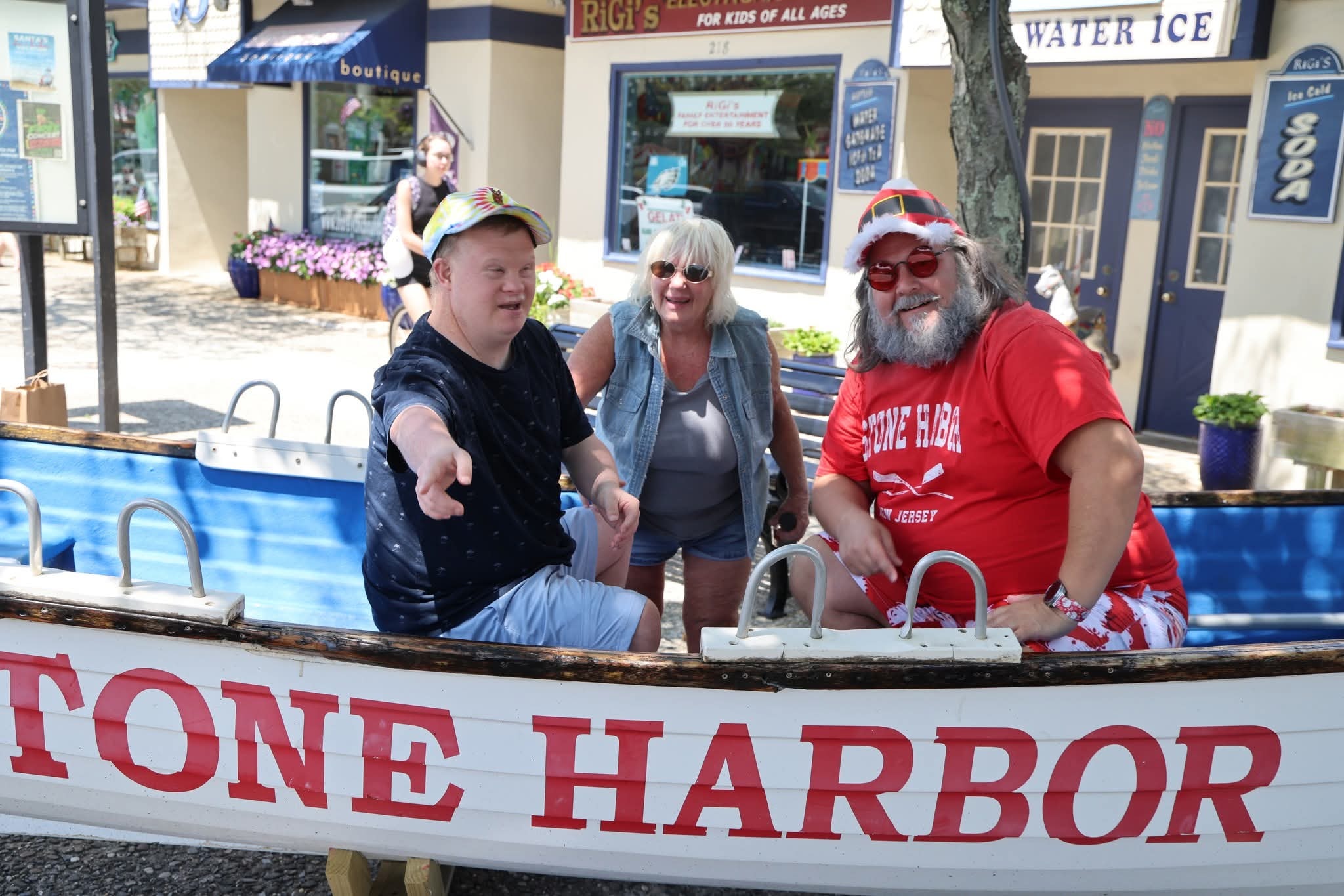 Cape May County Santa with a young man and a woman in the Stone Harbor boat, young man pointing and gesturing