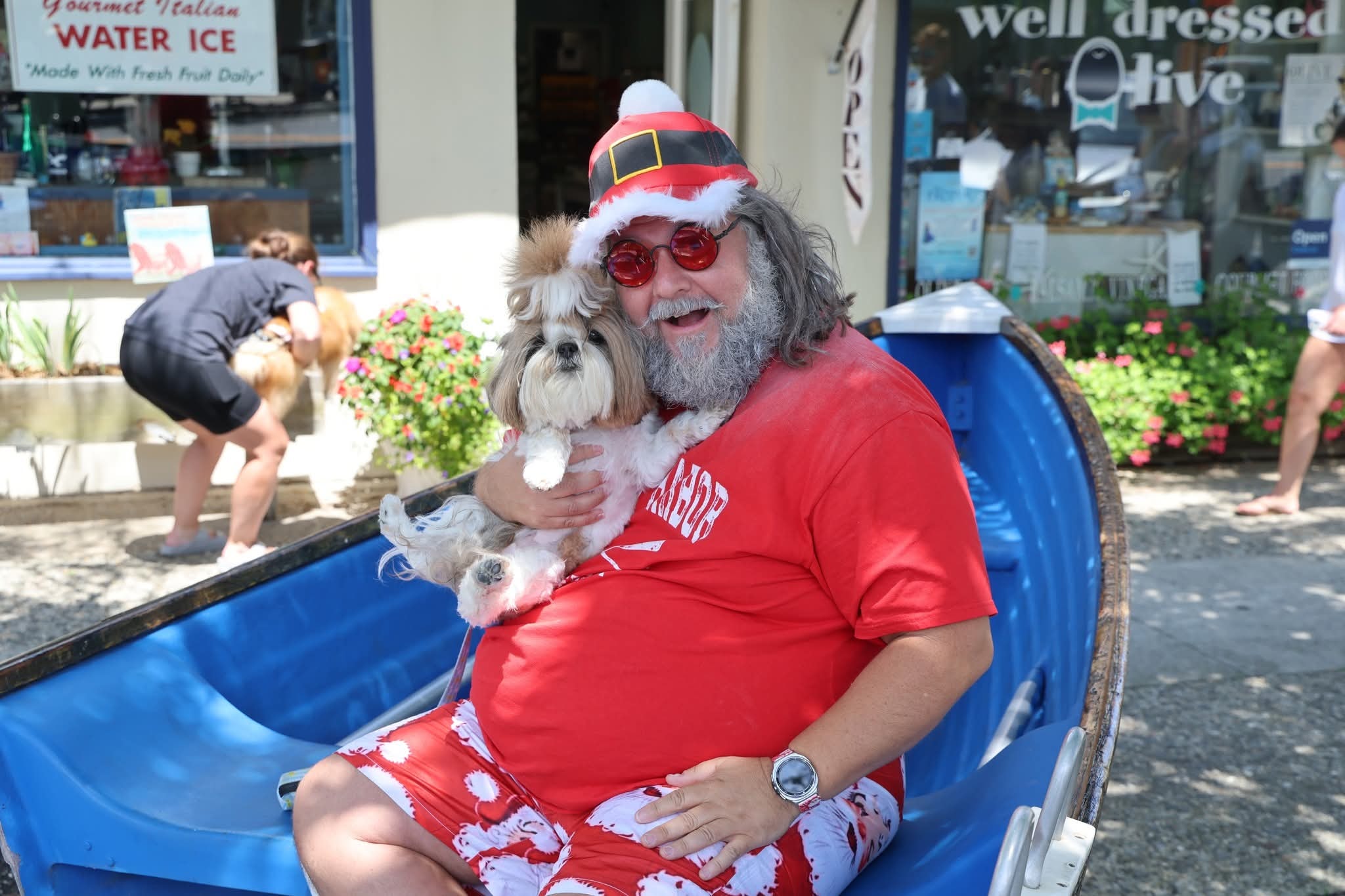 Cape May County Santa holding a Shih Tzu outside Well Dressed Olive in Stone Harbor
