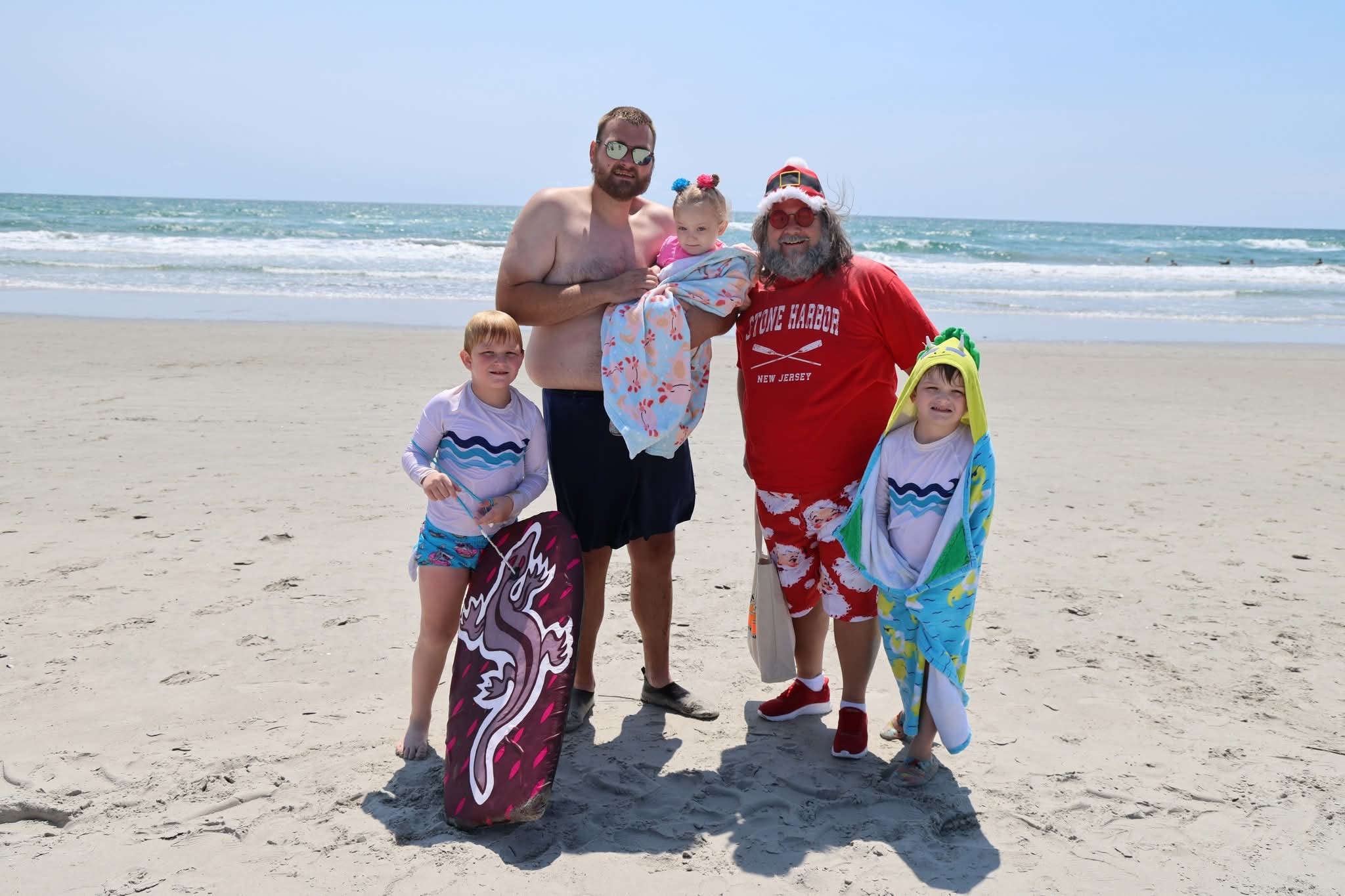 Cape May County Santa with a dad and three kids on the beach