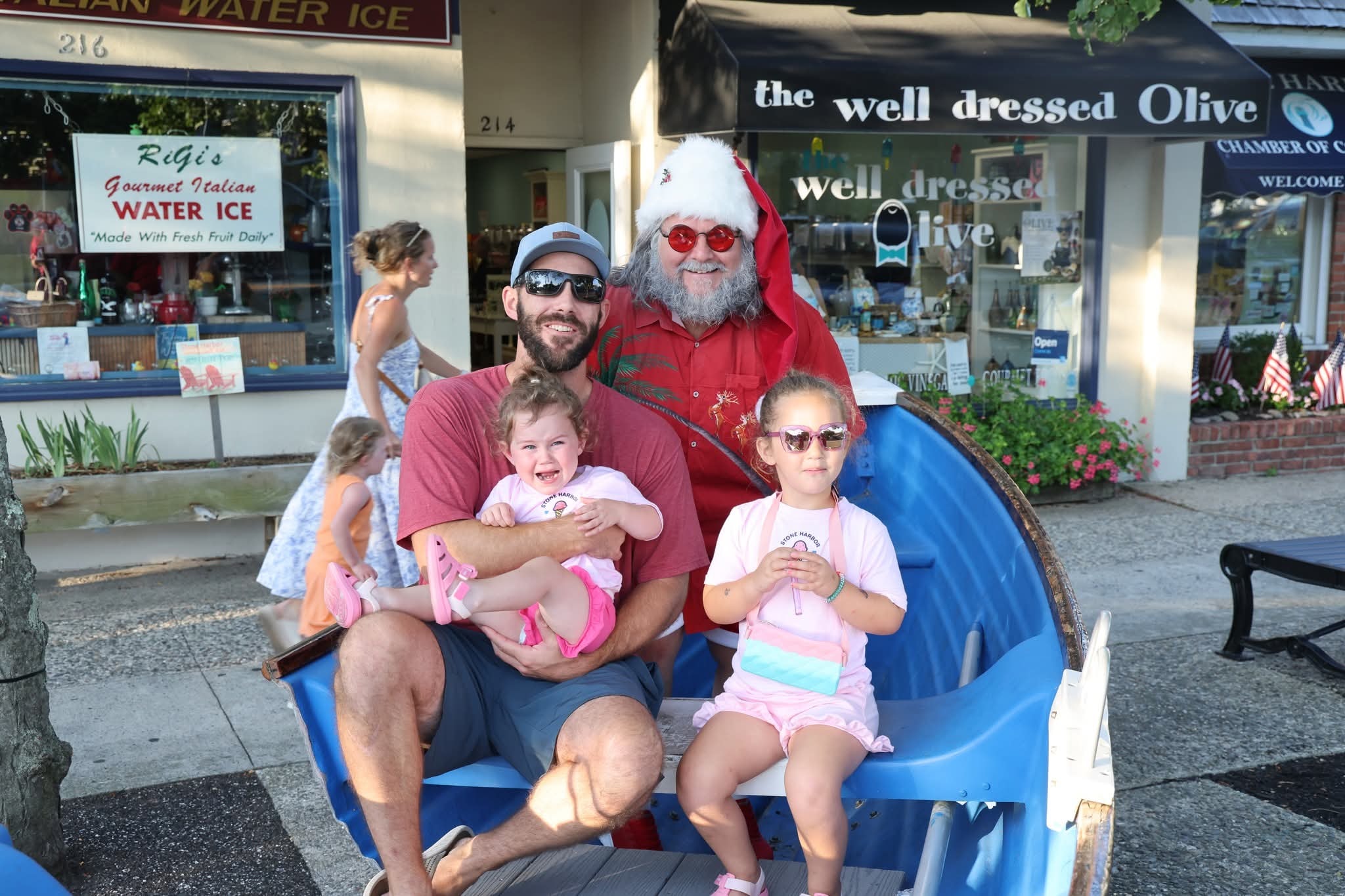 Cape May County Santa with a dad and two girls in the Stone Harbor boat near RiGi's Water Ice
