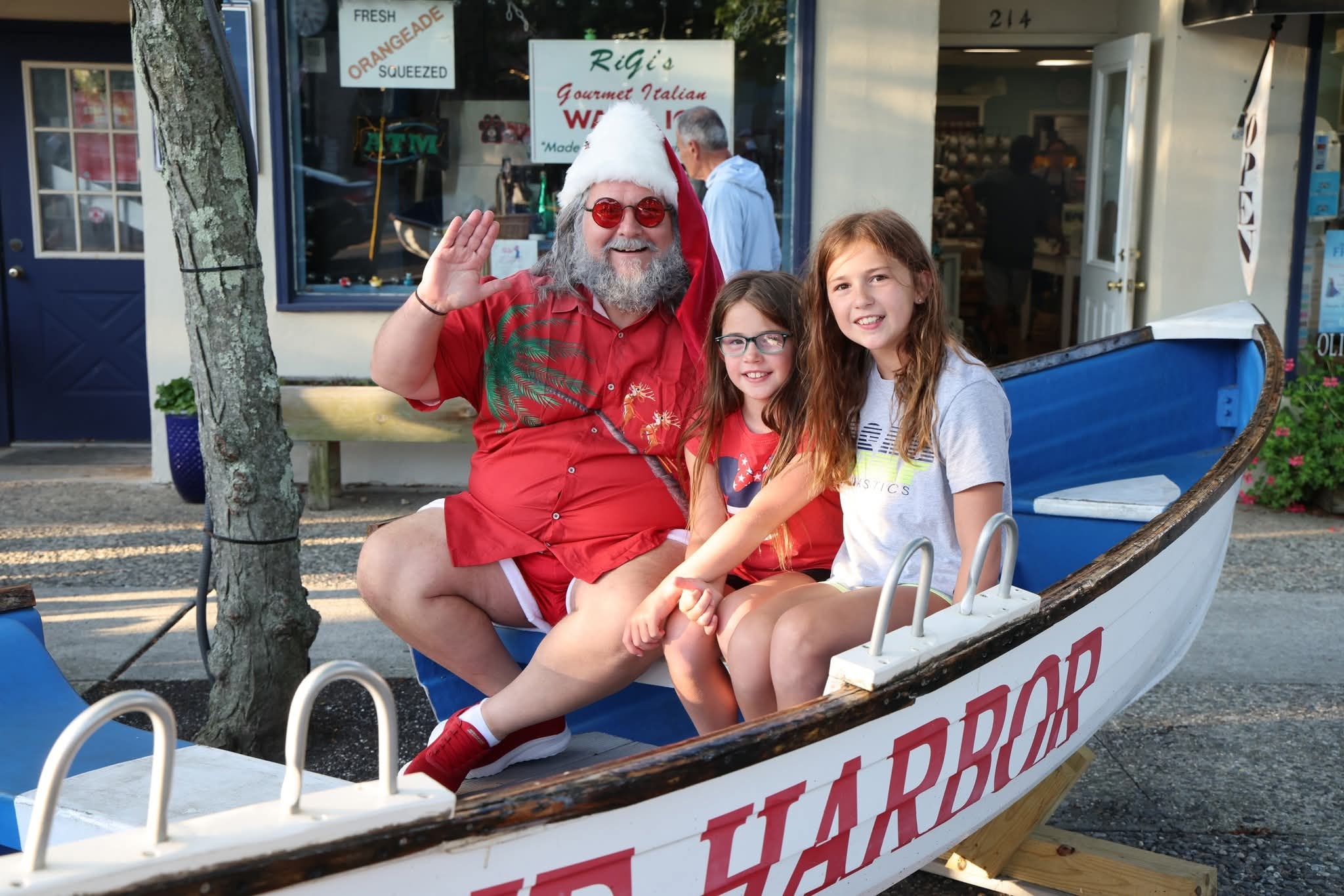 Cape May County Santa waving with two girls in the Stone Harbor boat