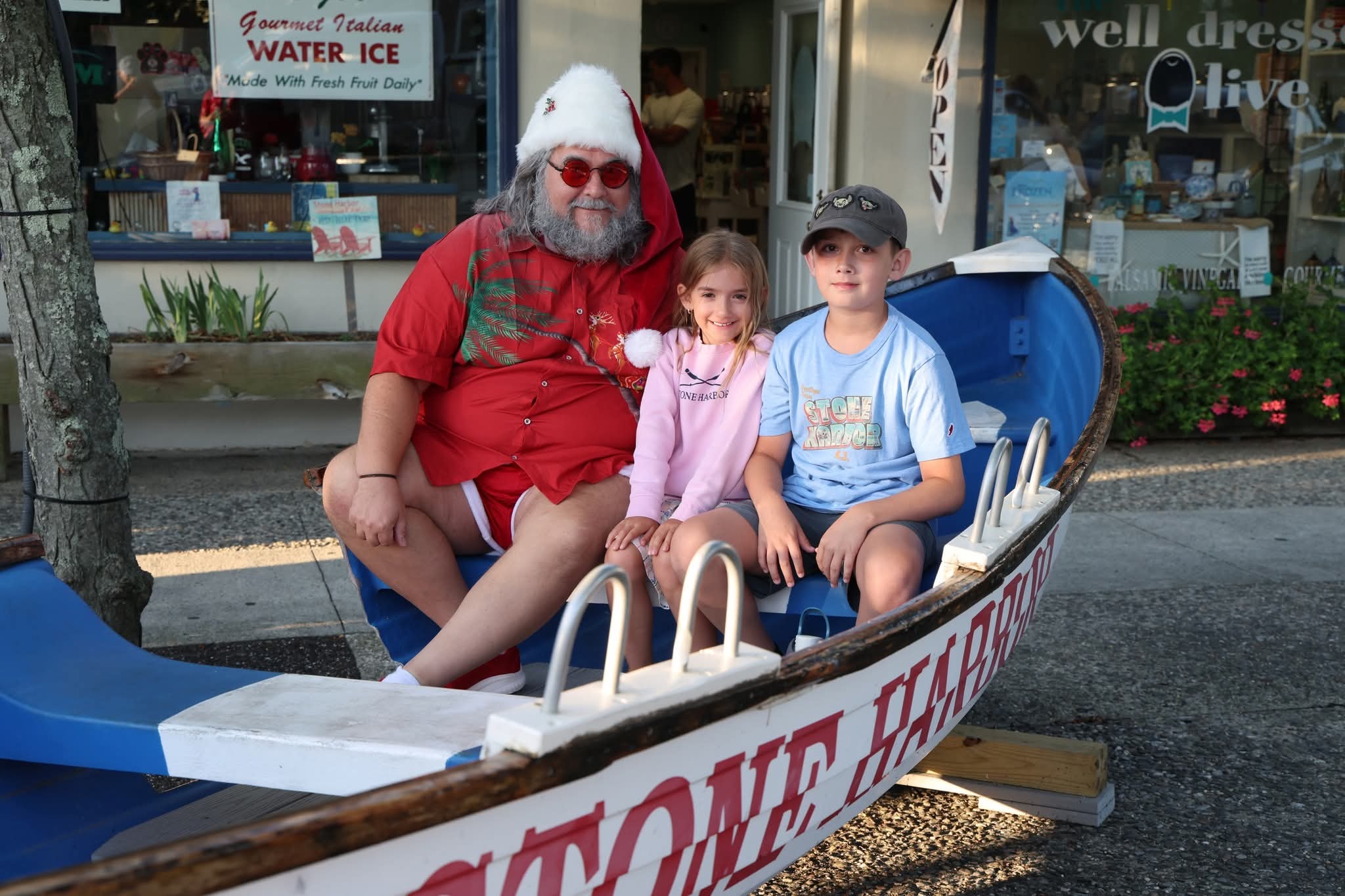 Cape May County Santa with a girl and boy in Stone Harbor shirts in the Stone Harbor boat