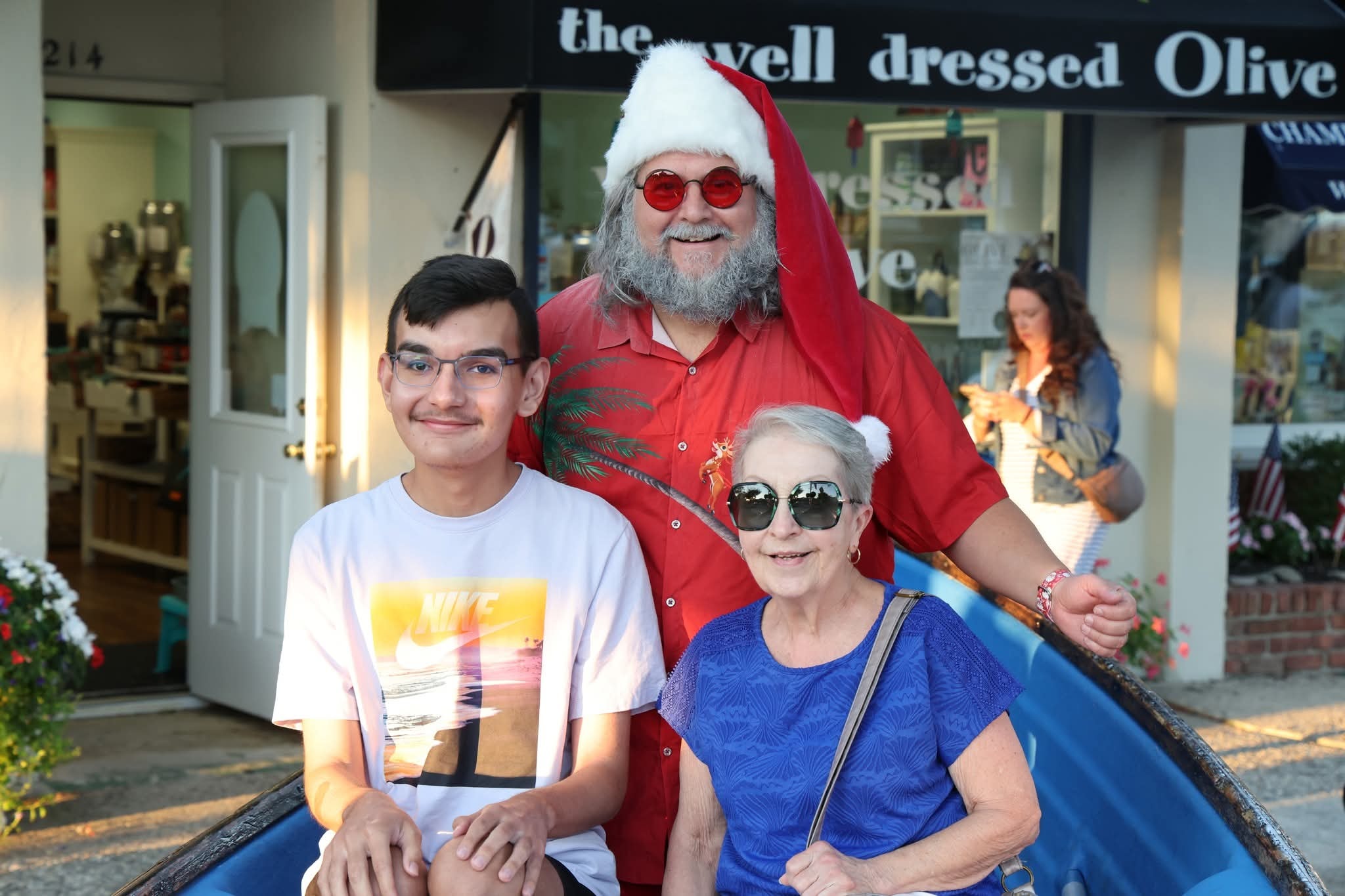 Cape May County Santa with a teenage boy in a Nike shirt and a grandmother in blue in the Stone Harbor boat