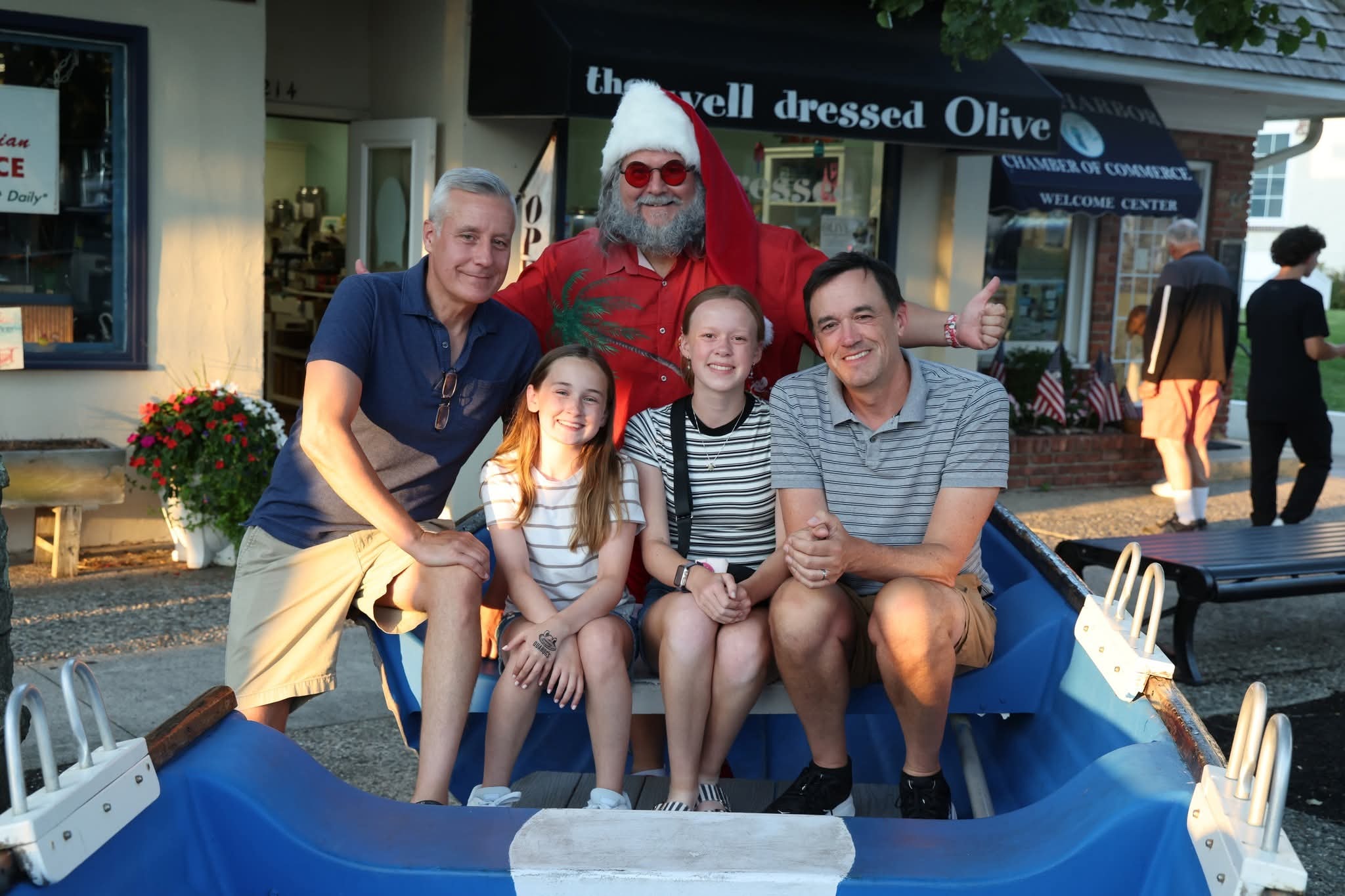 Cape May County Santa with two dads and two girls in the Stone Harbor boat at golden hour